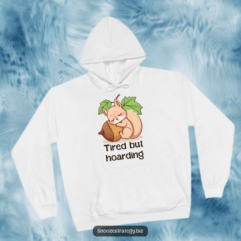 Funny hoodie featuring a drowsy squirrel character fast asleep, using a massive acorn as a comfortable pillow, radiating sleepiness.